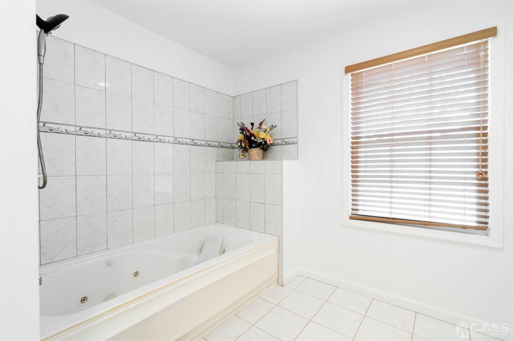 40 Kimberly Road Colonia, NJ 07067 - Photo 29 of 30 a white bath tub sitting next to a window