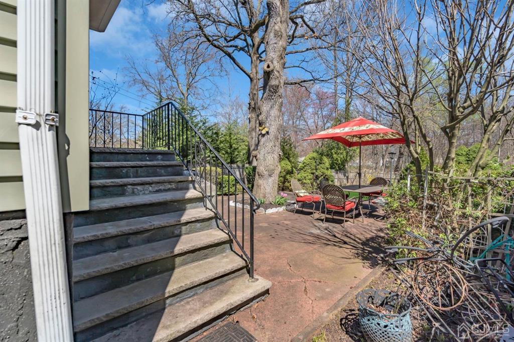 40 Kimberly Road Colonia, NJ 07067 - Photo 9 of 30 a view of a patio with a table and chairs under an umbrella