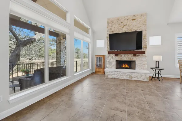 a large white kitchen with stainless steel appliances kitchen island granite countertop a large counter top space a sink stainless steel appliances and cabinets