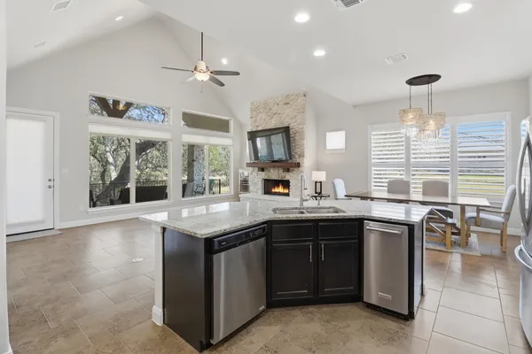 a kitchen with stainless steel appliances wooden cabinets a sink and a refrigerator