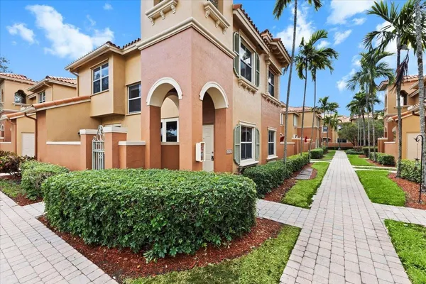 a view of a brick house with a yard