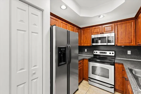a kitchen with stainless steel appliances a stove a microwave and cabinets