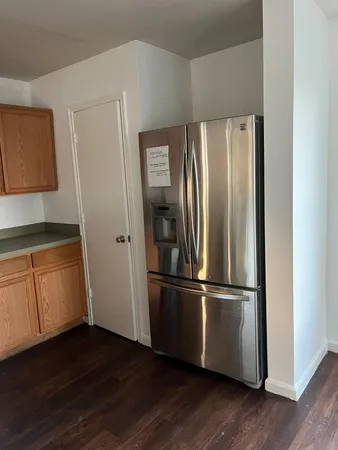 a metallic refrigerator freezer sitting in a kitchen