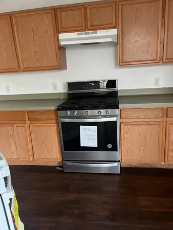 a stove top oven sitting inside of a kitchen