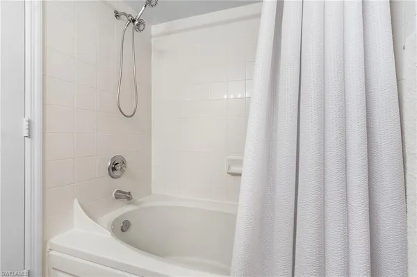 a bathroom with a bath tub and a shower curtain