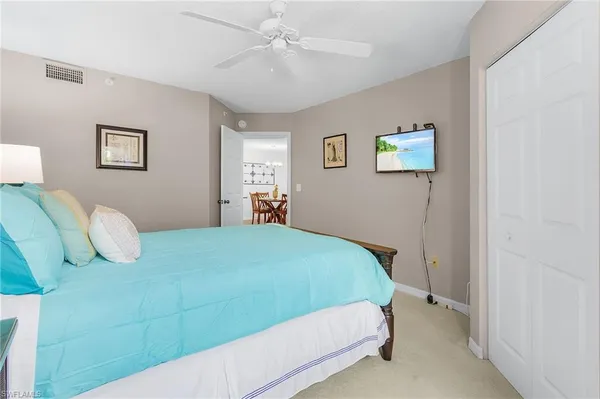 a bedroom with a bed and dresser