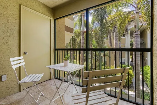 a view of a balcony with chair and wooden floor