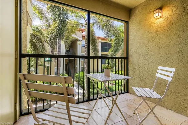 a view of a chair and table in the balcony