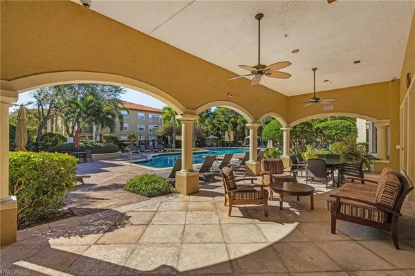 a view of a swimming pool with outdoor seating