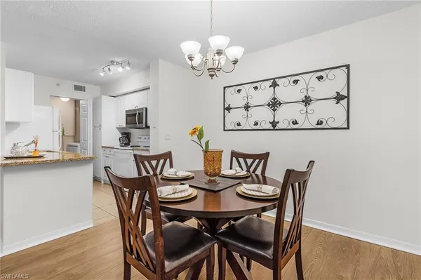a view of a dining room with furniture and chandelier