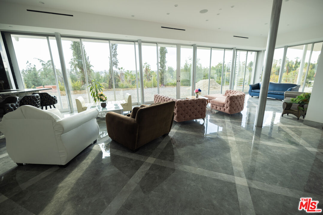 Undisclosed Address Woodland Hills, CA 91367 - Photo 17 of 75 a living room with furniture and a large window