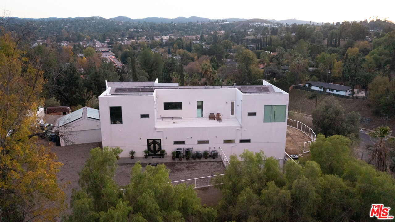 Undisclosed Address Woodland Hills, CA 91367 - Photo 2 of 75 an aerial view of a house with a garden