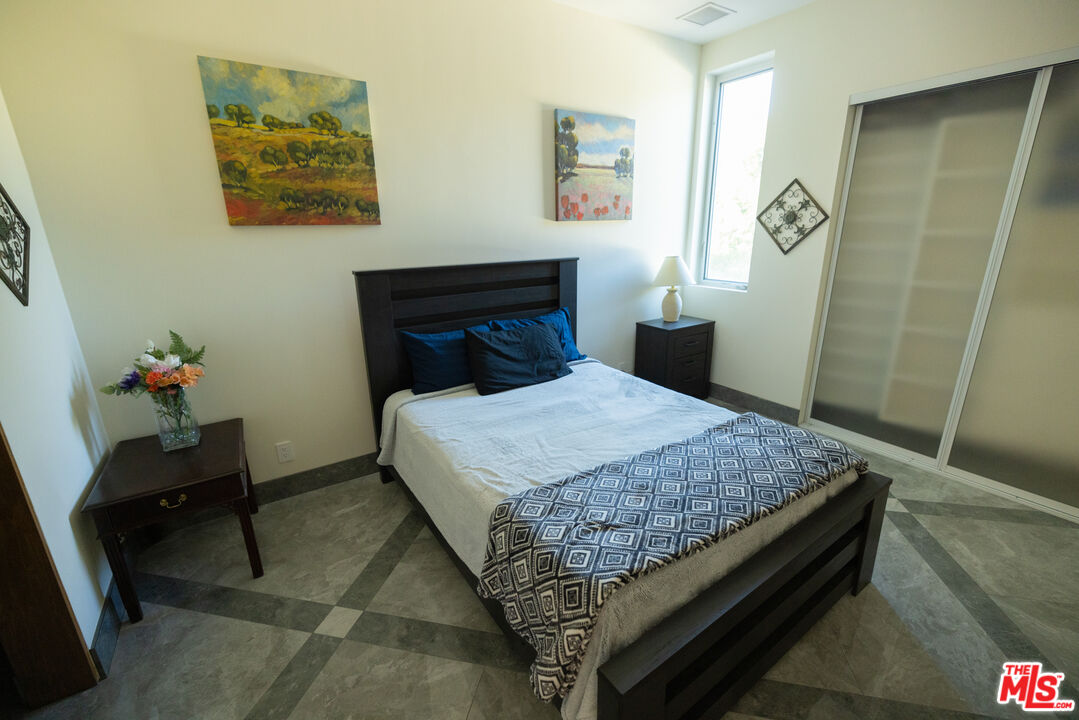 Undisclosed Address Woodland Hills, CA 91367 - Photo 29 of 75 a bedroom with a bed and a table in it