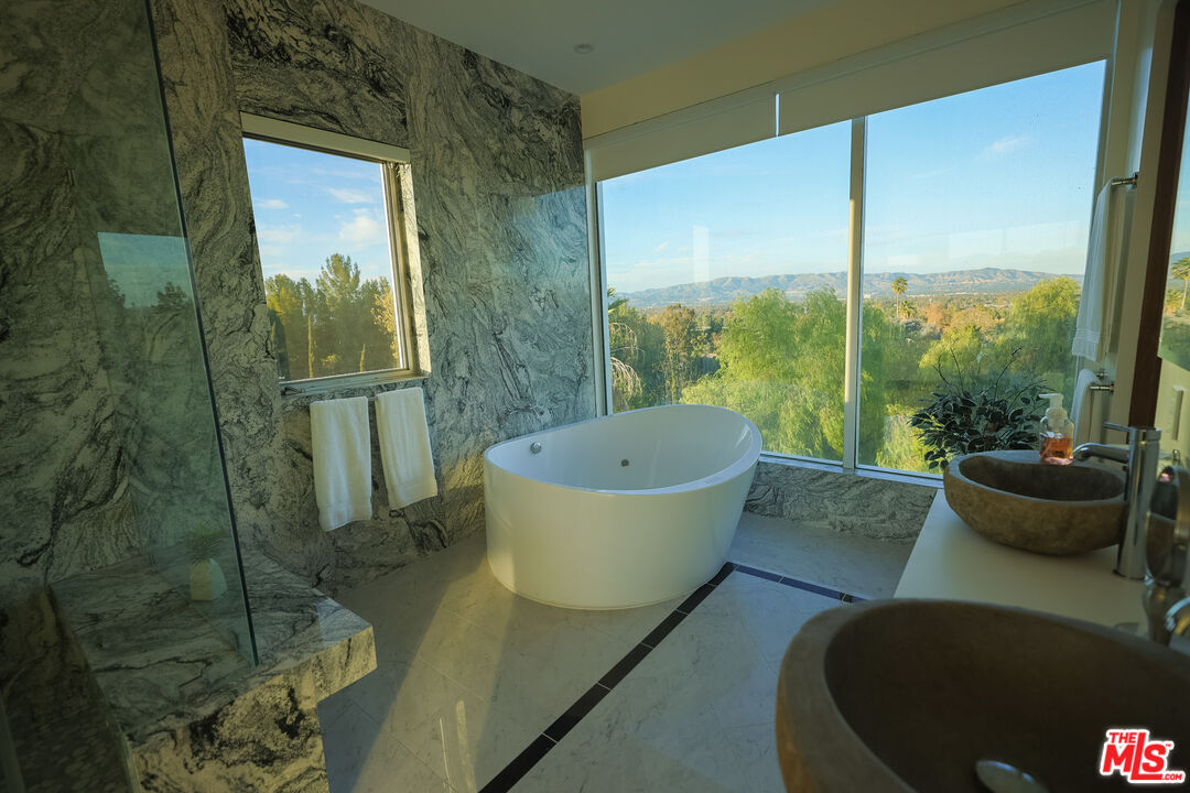 Undisclosed Address Woodland Hills, CA 91367 - Photo 36 of 75 a bathroom with a bathtub and shower