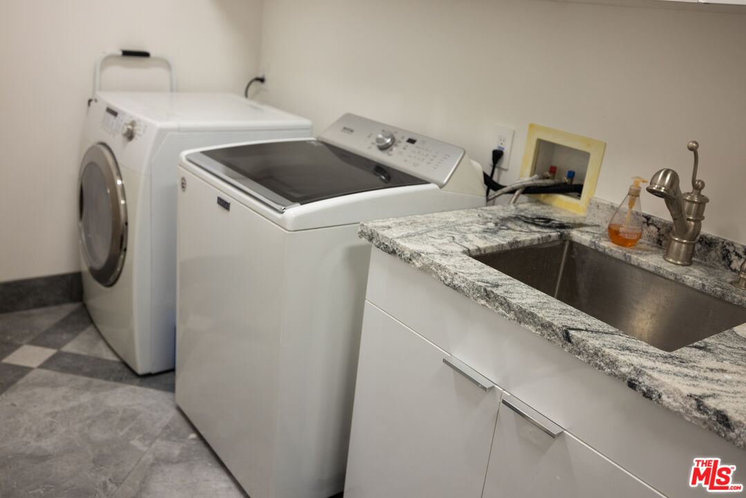 Undisclosed Address Woodland Hills, CA 91367 - Photo 39 of 75 a utility room with sink dryer and washer