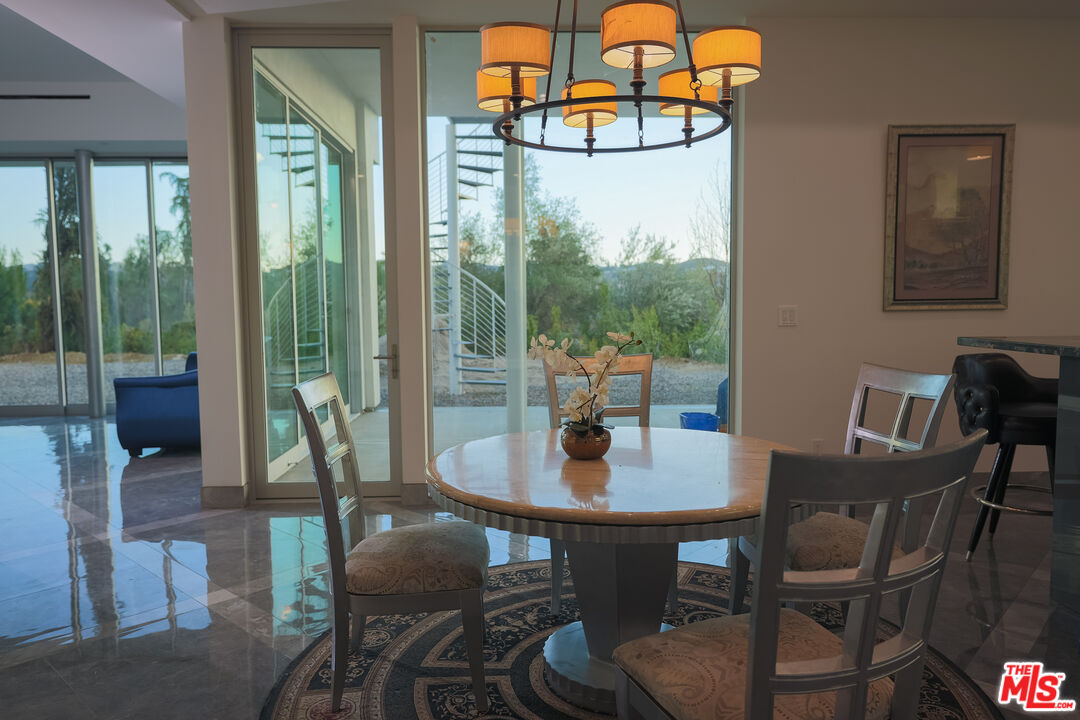 Undisclosed Address Woodland Hills, CA 91367 - Photo 48 of 75 a view of a dining room with furniture wooden floor and a potted plant