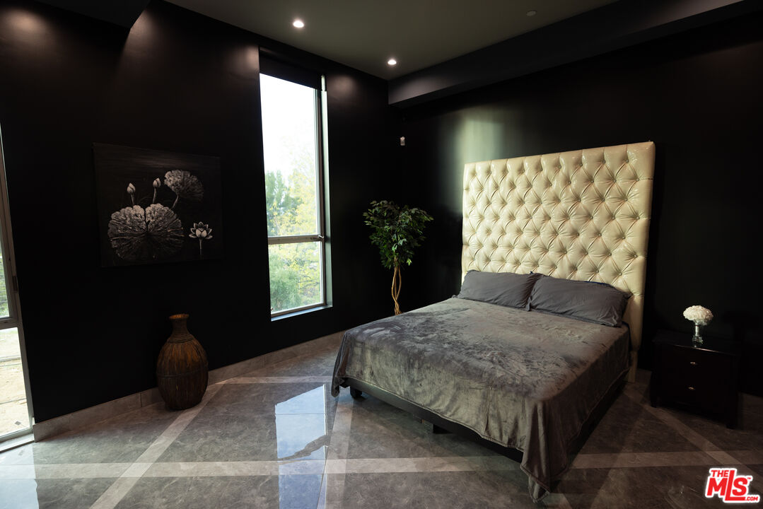 Undisclosed Address Woodland Hills, CA 91367 - Photo 49 of 75 a bedroom with a bed and a window