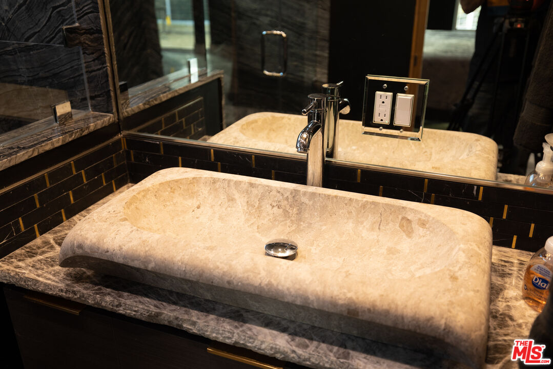 Undisclosed Address Woodland Hills, CA 91367 - Photo 52 of 75 a bed sitting in a bedroom next to a bathroom