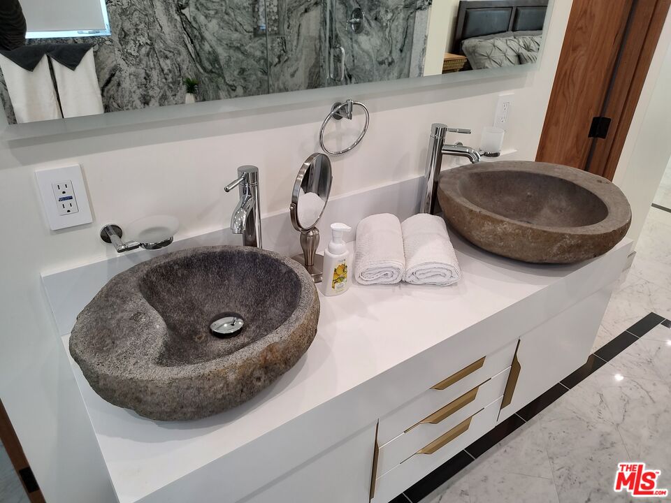 Undisclosed Address Woodland Hills, CA 91367 - Photo 57 of 75 a bathroom with a sink and a mirror