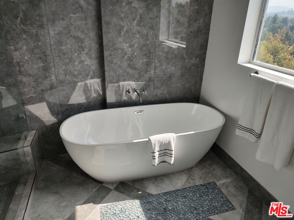 Undisclosed Address Woodland Hills, CA 91367 - Photo 58 of 75 a view of a bathtub in a bathroom