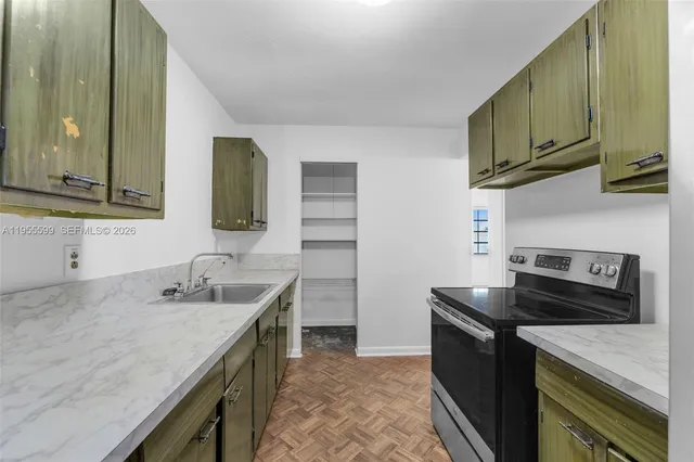 a kitchen with stainless steel appliances granite countertop a sink stove and cabinets