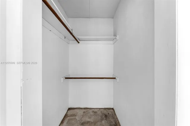 a view of walk in closet with clothes