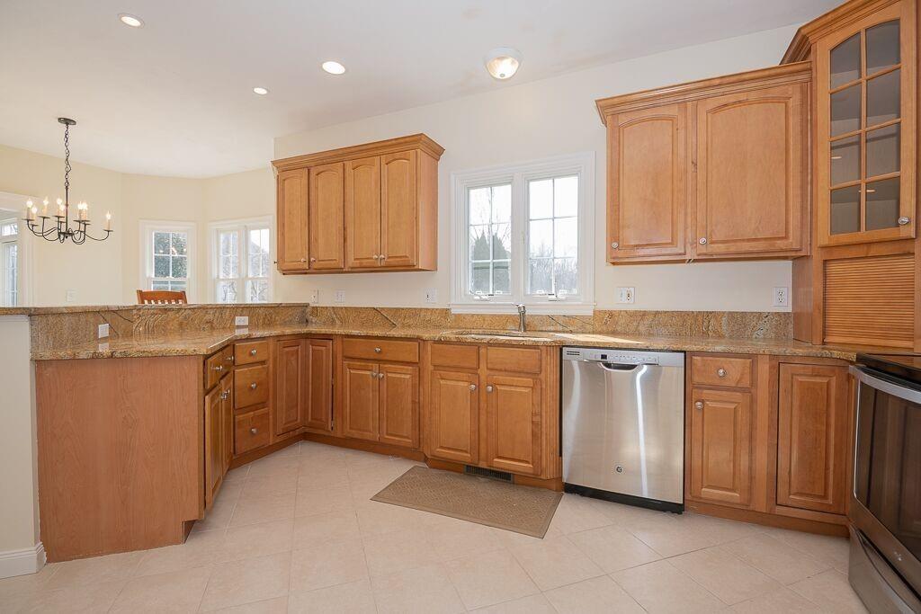 5 Boundary Stone Road Sutton, MA 01590 - Photo 14 of 42 a kitchen with granite countertop cabinets stainless steel appliances a sink and a window