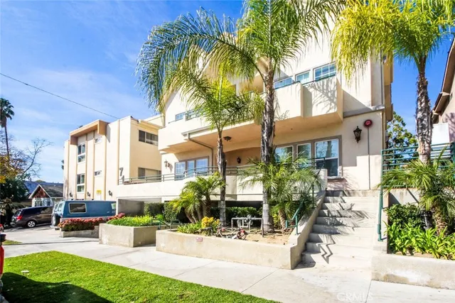 a view of a building with a patio and a garden