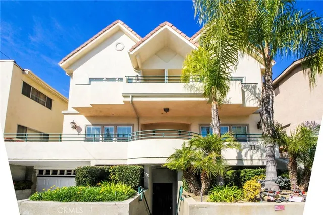 a front view of house with a garden