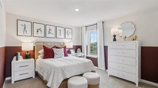 a bedroom with a large bed and a flat tv screen on dresser