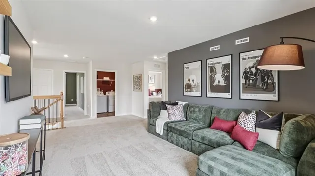 a living room with furniture and a potted plant