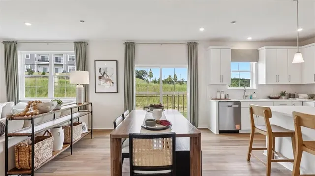 a living room with furniture kitchen view and a potted plant