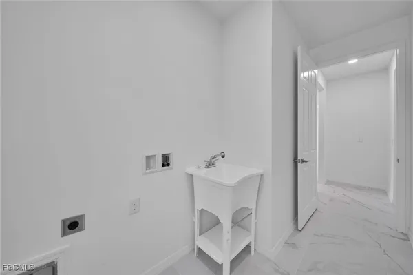 a view of an empty room with windows and storage