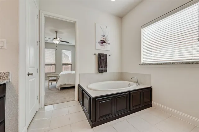 a bathroom with a granite countertop double vanity sink and a mirror
