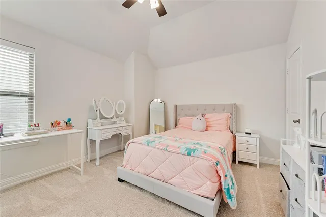 a bedroom with furniture and a lamp