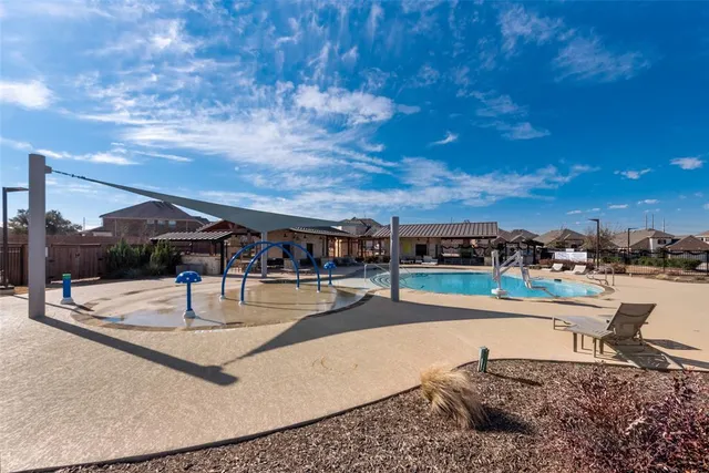 a backyard of a house with table and chairs