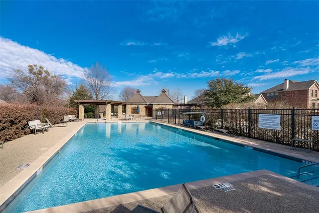 a swimming pool with chairs