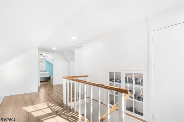 a view of entryway and hall with wooden floor