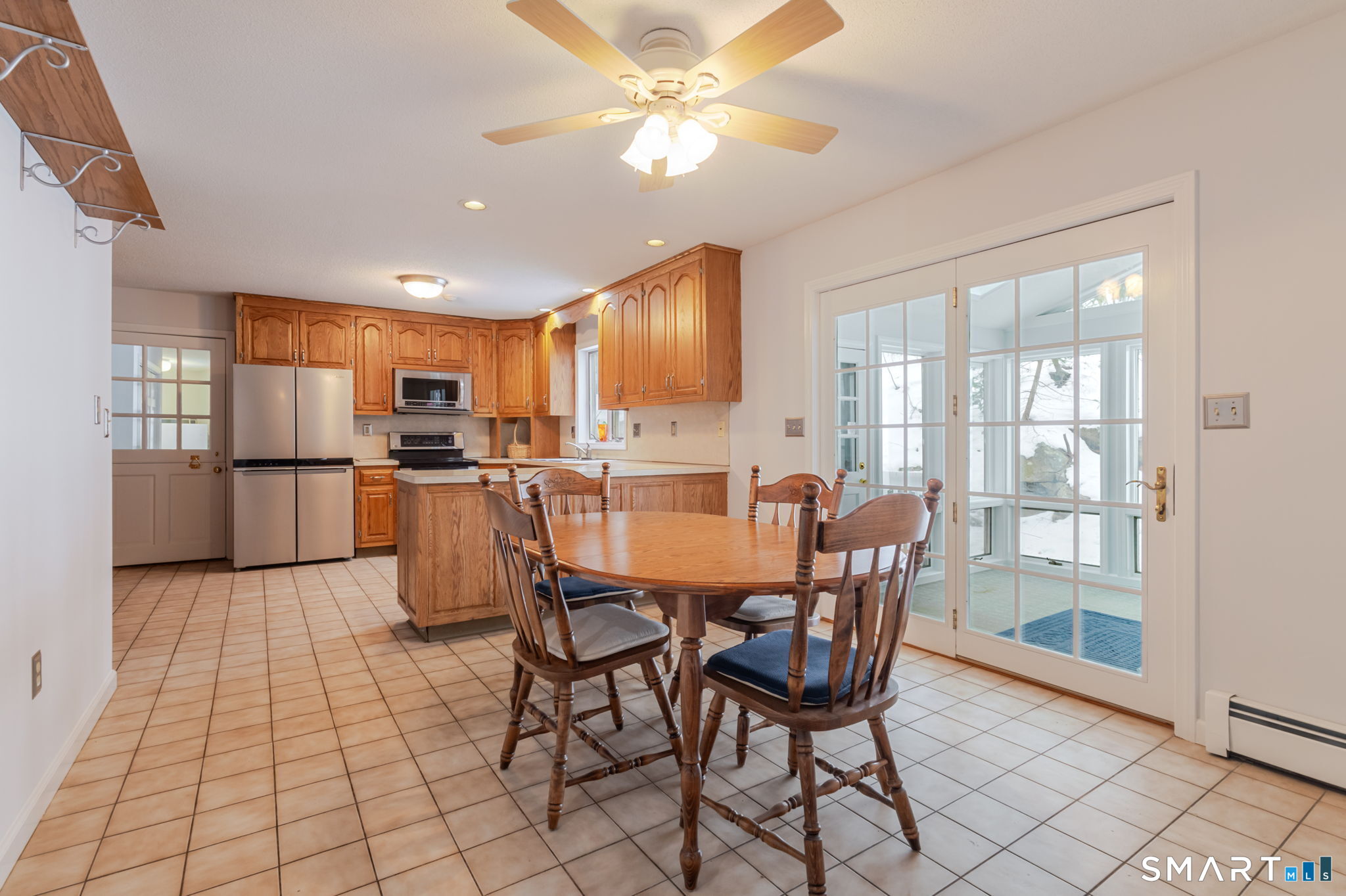 279 Old Mountain Road Southington, CT 06444 - Photo 6 of 37 a kitchen with stainless steel appliances kitchen island granite countertop a refrigerator a stove a microwave oven with a dining table and chairs