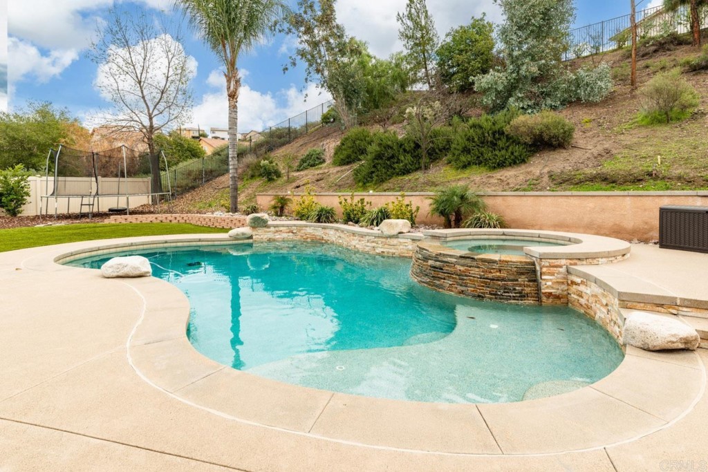 34063 Abbey Road Temecula, CA 92592 - Photo 16 of 33 a view of a swimming pool with a yard