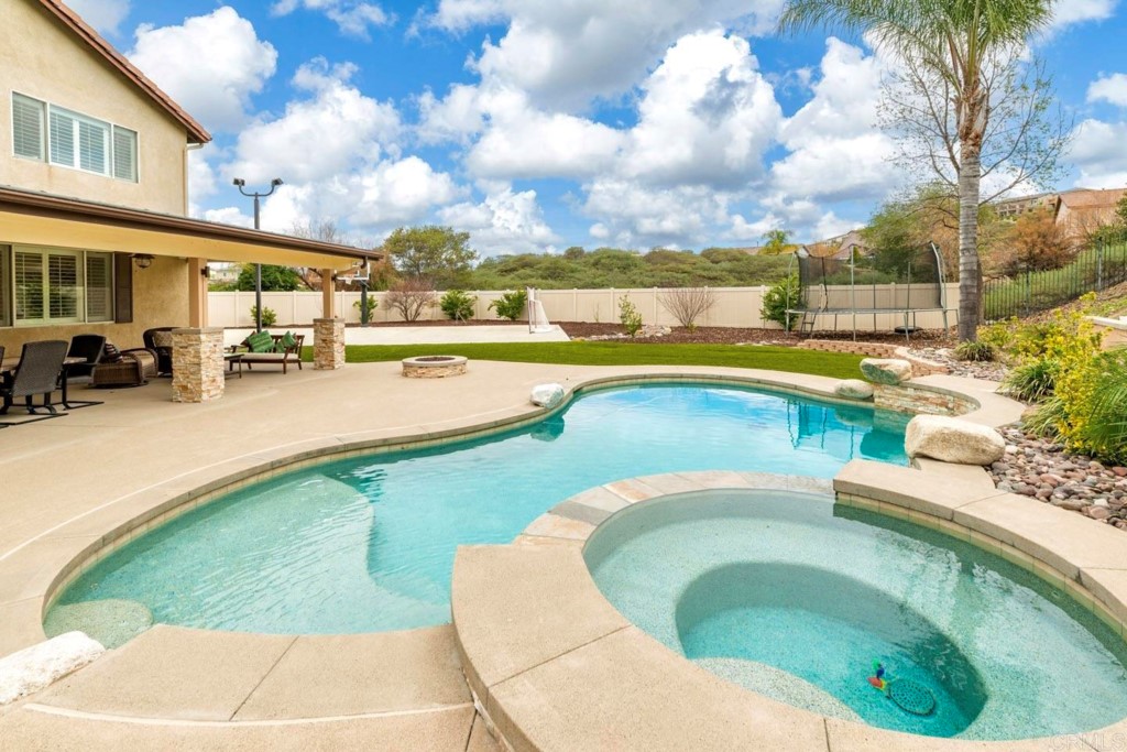 34063 Abbey Road Temecula, CA 92592 - Photo 2 of 33 a swimming pool with outdoor seating and barbeque oven