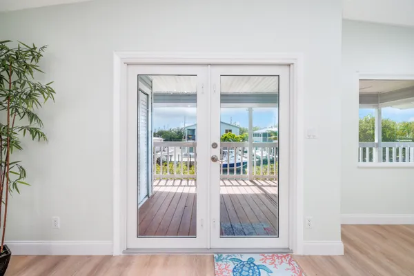 a view of a dining room with wooden floor and outdoor space