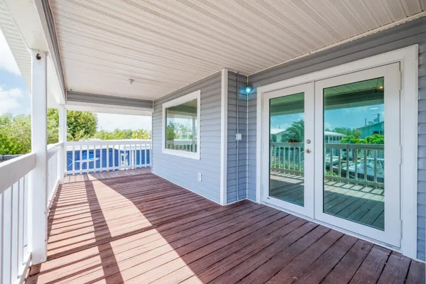 a view of outdoor space with wooden floor and stairs