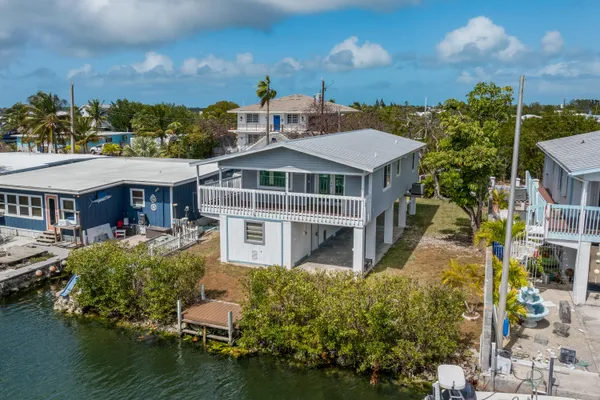 a aerial view of a house with swimming pool and a yard