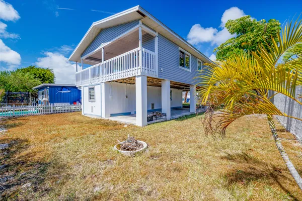 a view of a room with wooden floor and a ceiling fan