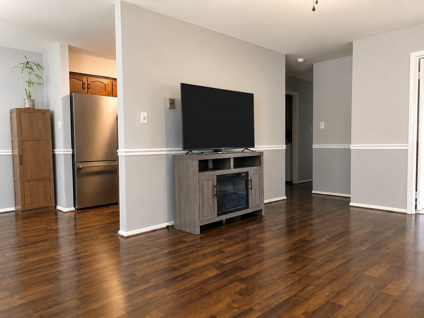 7006 Basswood Road Frederick, MD 21703 - Photo 3 of 10 a view of a livingroom with wooden floor and a flat screen tv