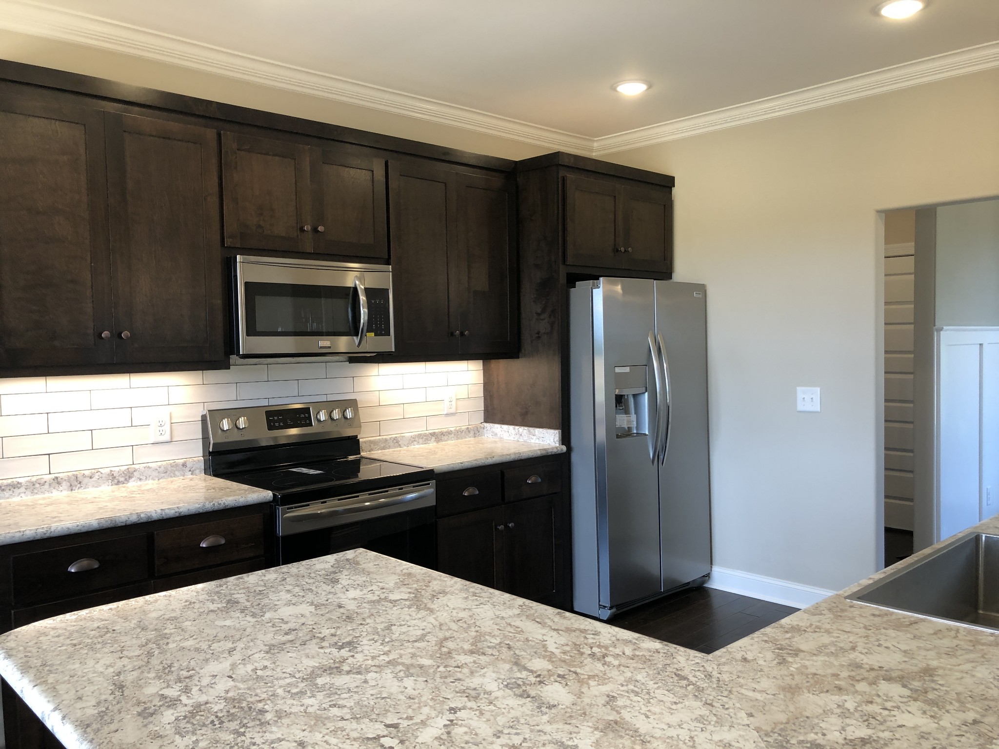 2096 Longview Road Bell Buckle, TN 37020 - Photo 8 of 27 a kitchen with granite countertop a refrigerator and a stove top oven