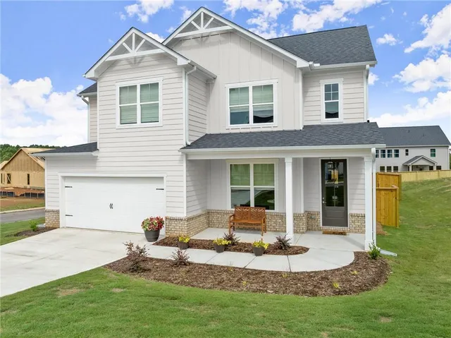 a view of a house with a yard porch and sitting area