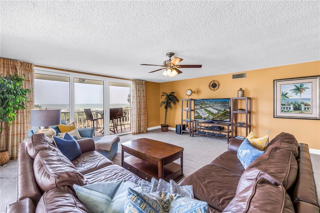 6600 Sunset Way, Unit 118 St. Pete Beach, FL 33706 - Photo 11 of 64 a living room with furniture and a large window