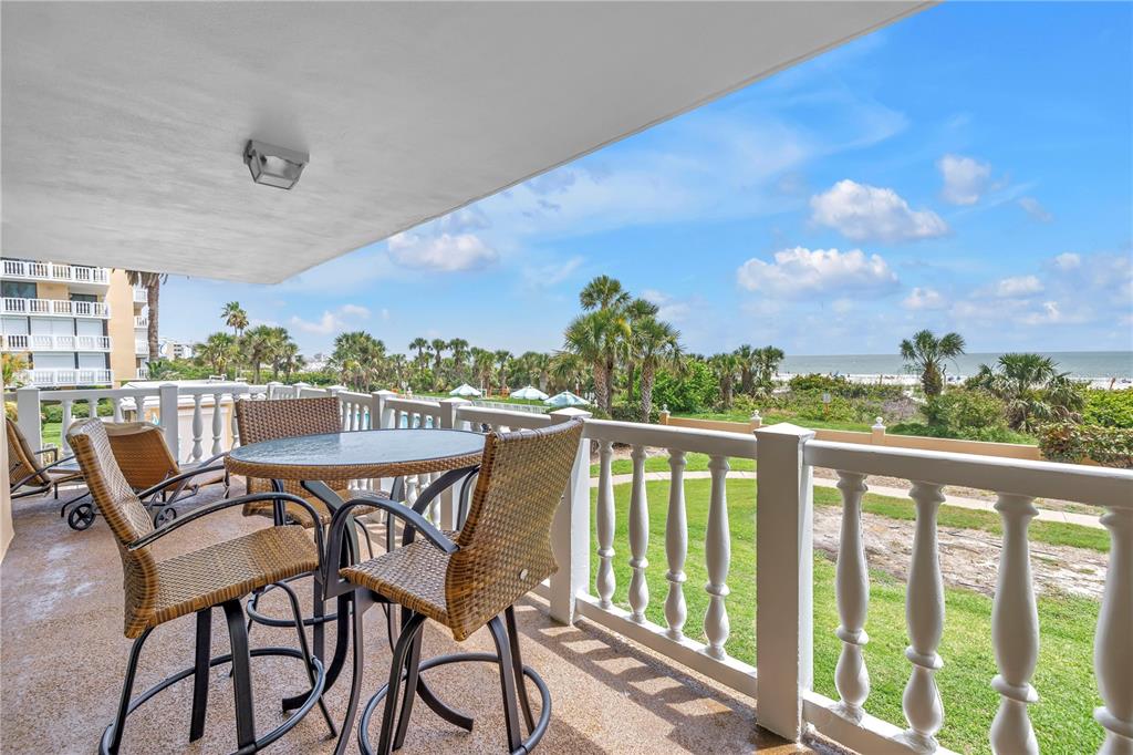6600 Sunset Way, Unit 118 St. Pete Beach, FL 33706 - Photo 13 of 64 a view of a balcony with furniture and a table